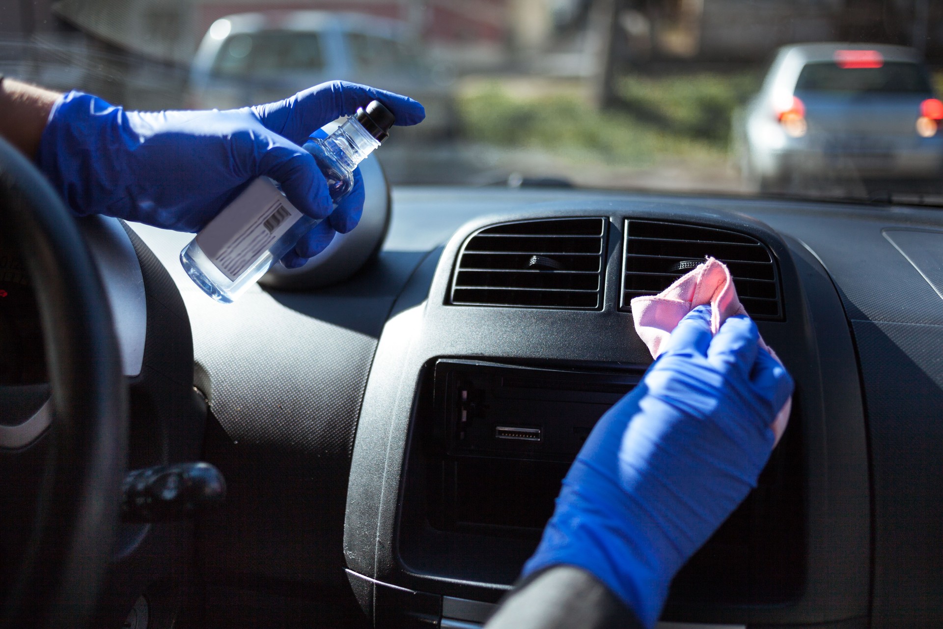 Woman wiping down steering wheel